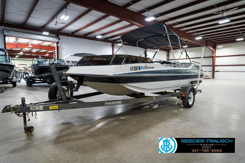 Slide: The Image of 1987 Hurricane 176 Deck Boat on trailer in indoor showroom, Reeder-Trausch Marine. - 4