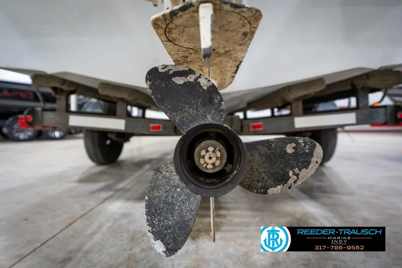 Slide: The Image of Propeller of 1987 Hurricane 176 Deck Boat on trailer in garage. - 42