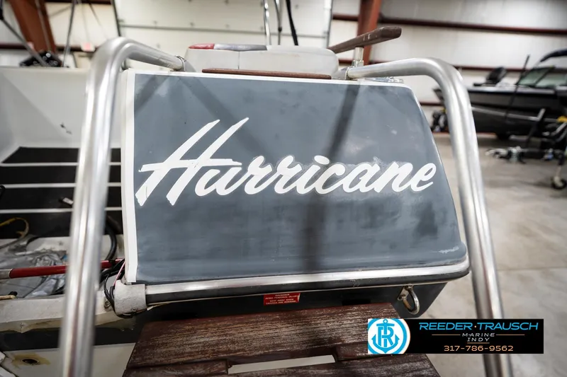 Slide: The Image of 1987 Hurricane 176 Deck Boat in a showroom, featuring prominent branding. - 44