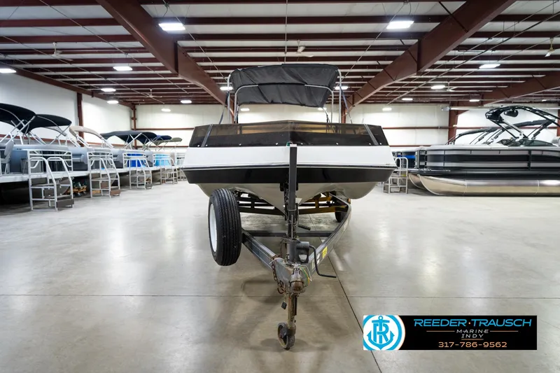 Slide: The Image of 1987 Hurricane 176 Deck Boat on trailer in indoor showroom. - 5