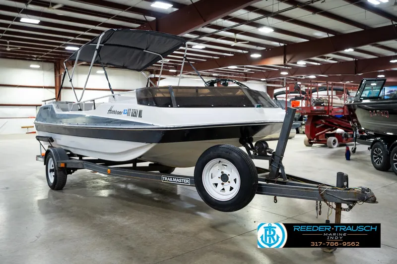 Slide: The Image of 1987 Hurricane 176 Deck Boat on trailer in indoor showroom. - 6