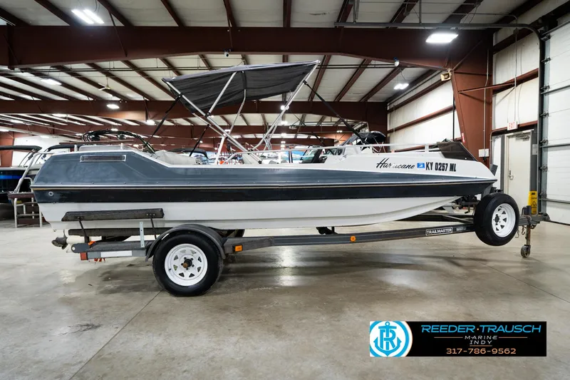 Slide: The Image of 1987 Hurricane 176 Deck Boat on trailer in indoor showroom. - 7