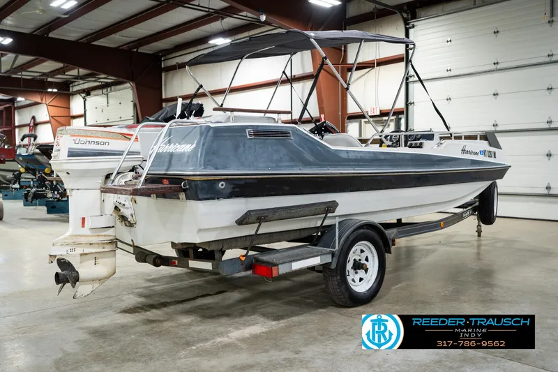 Slide: The Image of 1987 Hurricane 176 Deck Boat on trailer in indoor storage facility. - 8