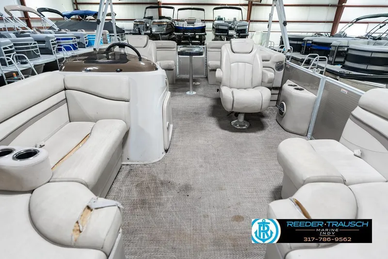 Slide: The Image of 2018 Bennington 20 SSRX pontoon boat interior with beige seating and steering console. - 16