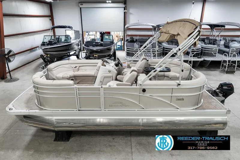 The Image of 2018 Bennington 20 SSRX pontoon boat in showroom with other boats. - 2