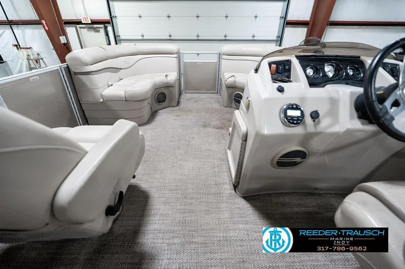 Slide: The Image of Interior of a 2018 Bennington 20 SSRX pontoon boat with beige seating and control panel. - 20
