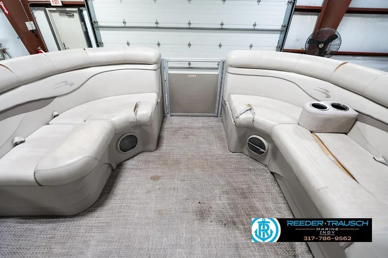 Slide: The Image of 2018 Bennington 20 SSRX boat interior with beige seating and cup holders. - 21