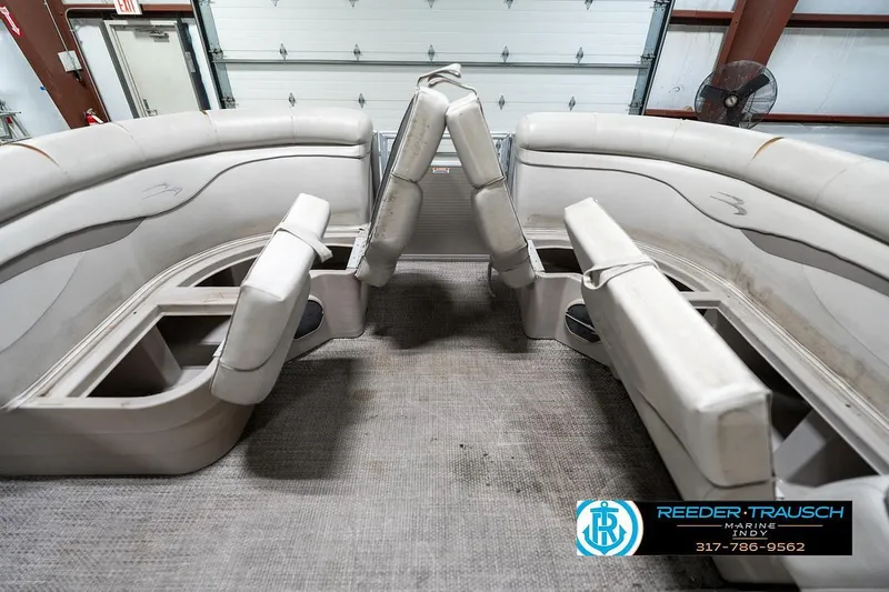 Slide: The Image of 2018 Bennington 20 SSRX pontoon boat interior with white seating and storage compartments. - 23