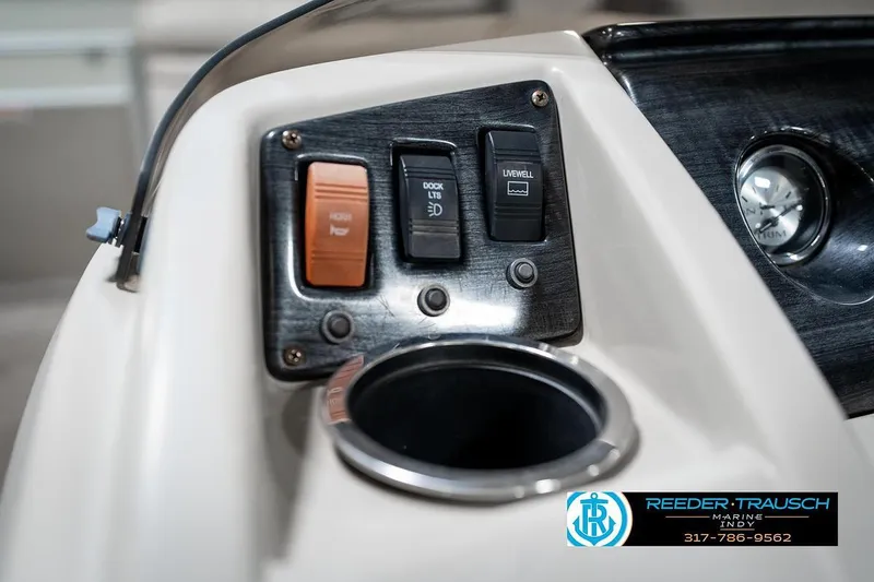 Slide: The Image of Control panel of a 2018 Bennington 20 SSRX boat with switches and cup holder. - 31