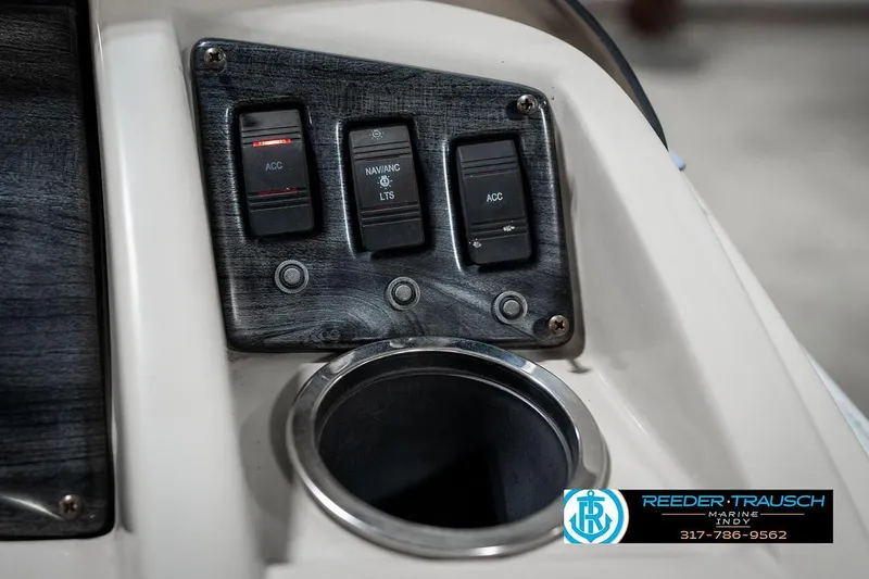 Slide: The Image of Control panel of 2018 Bennington 20 SSRX boat with switches and cup holder. - 34