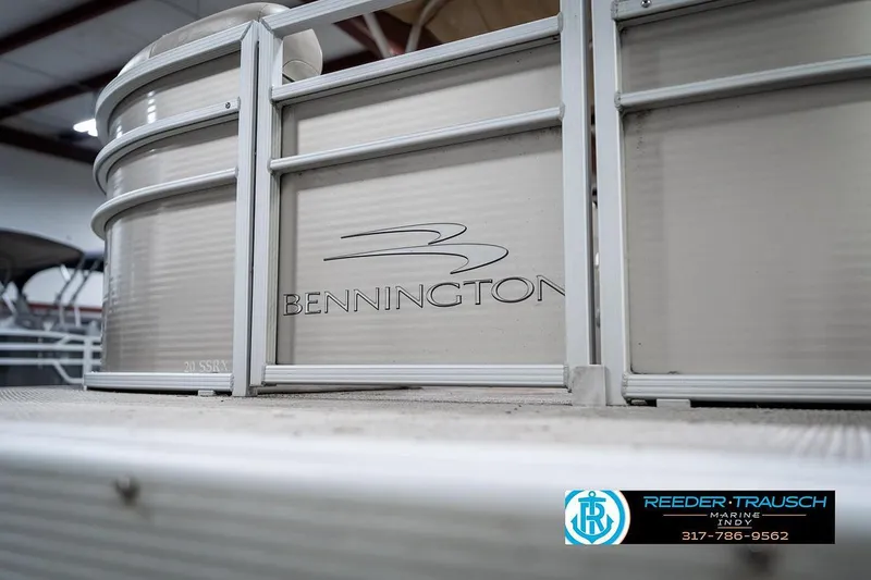 Slide: The Image of 2018 Bennington 20 SSRX pontoon boat with logo, displayed indoors. - 43