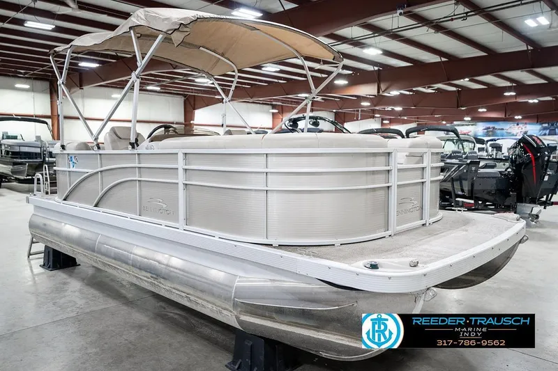 Slide: The Image of 2018 Bennington 20 SSRX pontoon boat in showroom with canopy and seating. - 6