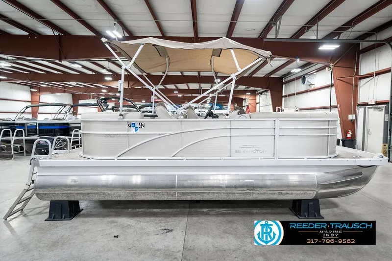 Slide: The Image of 2018 Bennington 20 SSRX pontoon boat in indoor showroom, side view. - 7