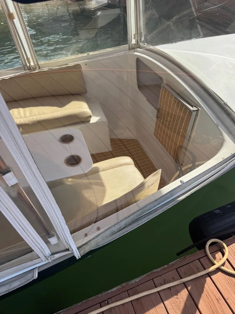 Slide: The Image of Interior view of a 1994 Duffy Classic 21 boat with beige seating and table. - 4