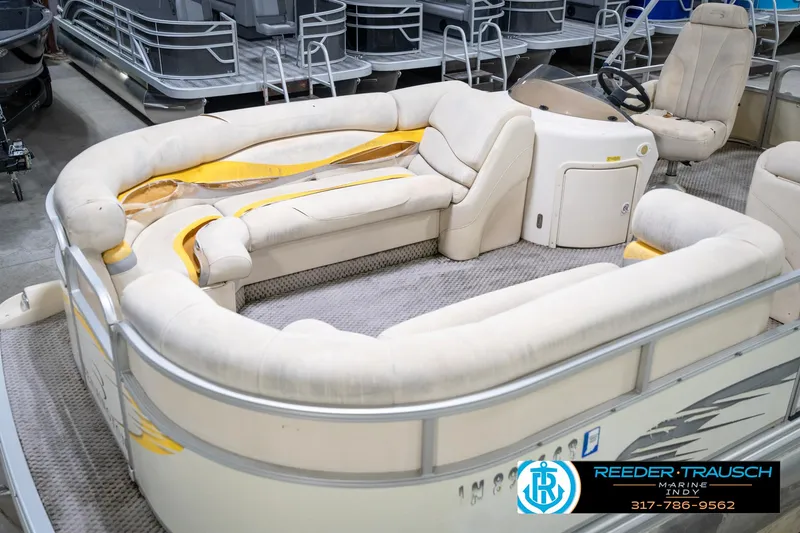Slide: The Image of 2005 Bennington 2050 pontoon boat with beige seating and steering console. - 11