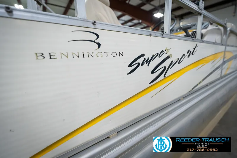 Slide: The Image of 2005 Bennington 2050 Super Sport boat with yellow accents, displayed indoors. - 17
