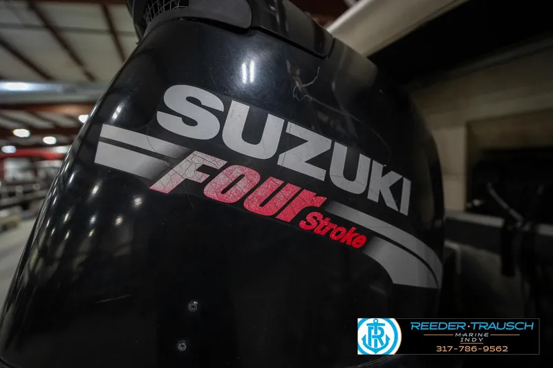 Slide: The Image of Suzuki Four Stroke engine on a 2005 Bennington 2050 boat, indoor setting. - 18