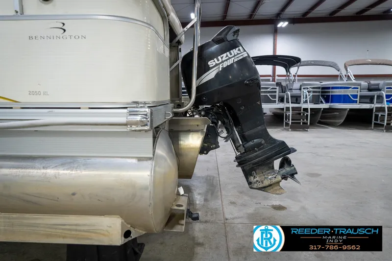 Slide: The Image of 2005 Bennington 2050 pontoon boat with Suzuki outboard motor in a showroom. - 22