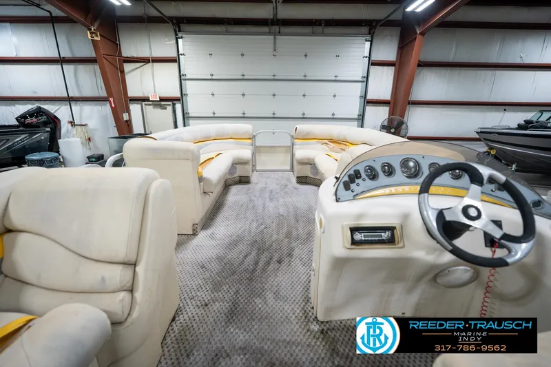 Slide: The Image of Interior of a 2005 Bennington 2050 pontoon boat in a garage setting. - 27