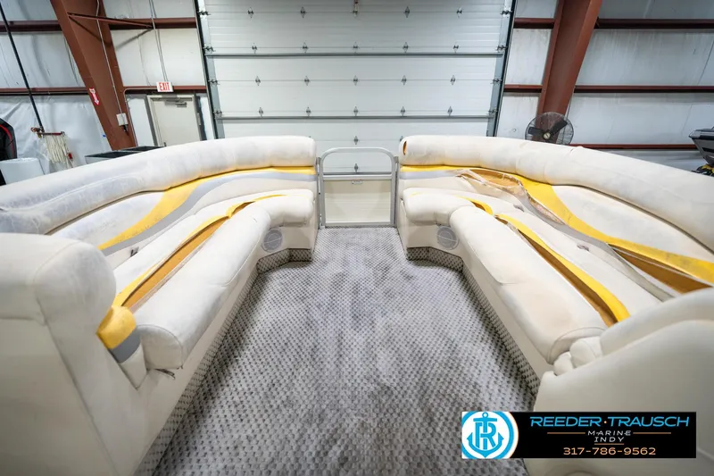 Slide: The Image of Interior of a 2005 Bennington 2050 boat with plush seating in a showroom. - 28