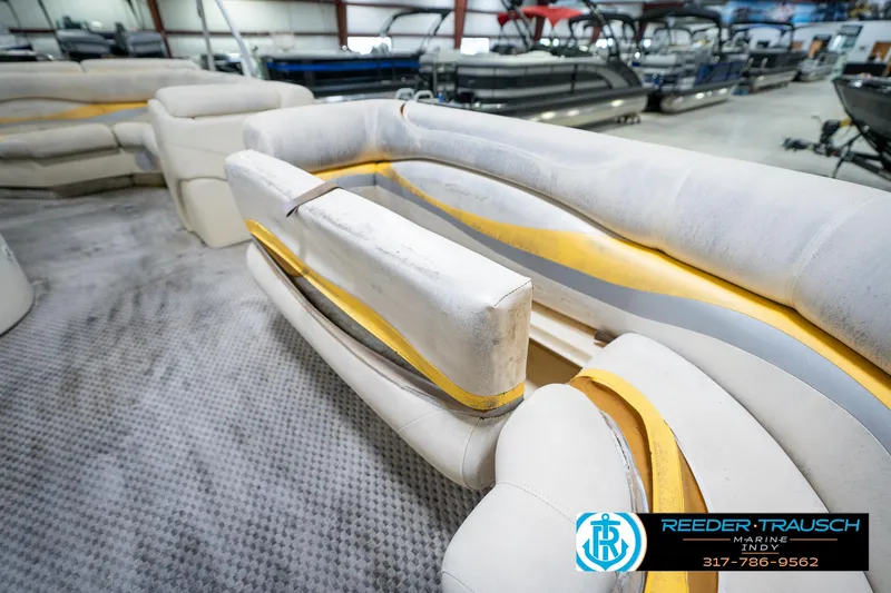 Slide: The Image of Interior of a 2005 Bennington 2050 pontoon boat with beige seating. - 29