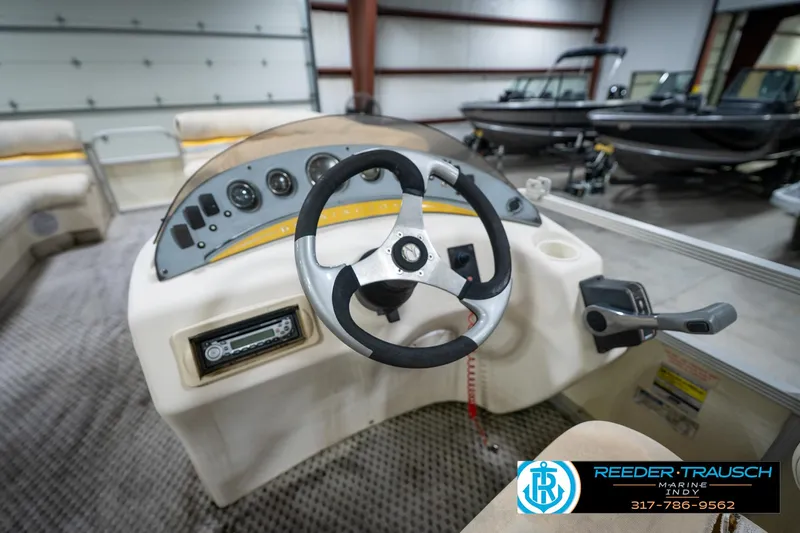 Slide: The Image of Steering console of a 2005 Bennington 2050 boat in a showroom. - 32