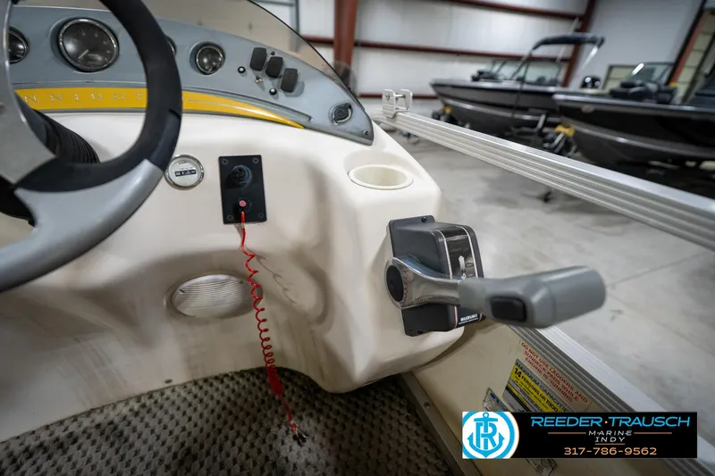 Slide: The Image of Interior view of a 2005 Bennington 2050 boat dashboard with steering wheel and controls. - 36
