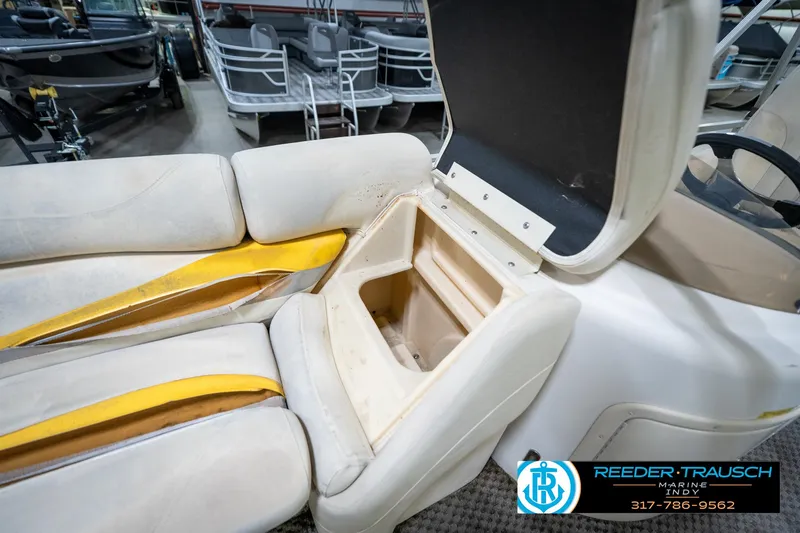 Slide: The Image of Open storage compartment on a 2005 Bennington 2050 boat with visible seating. - 39