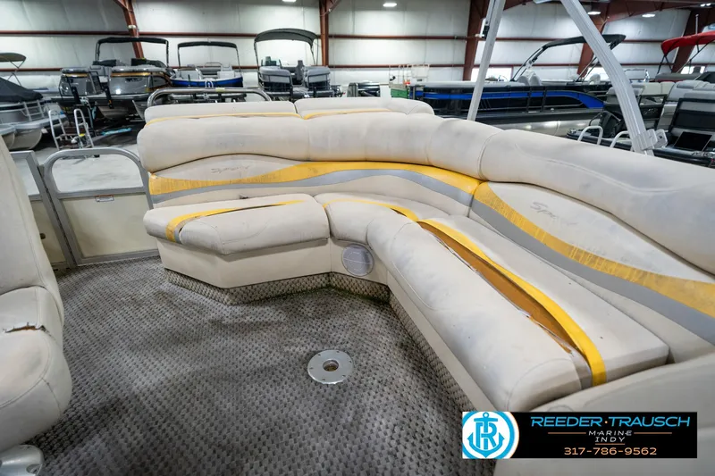 Slide: The Image of Interior of a 2005 Bennington 2050 boat with worn seating in a showroom. - 44