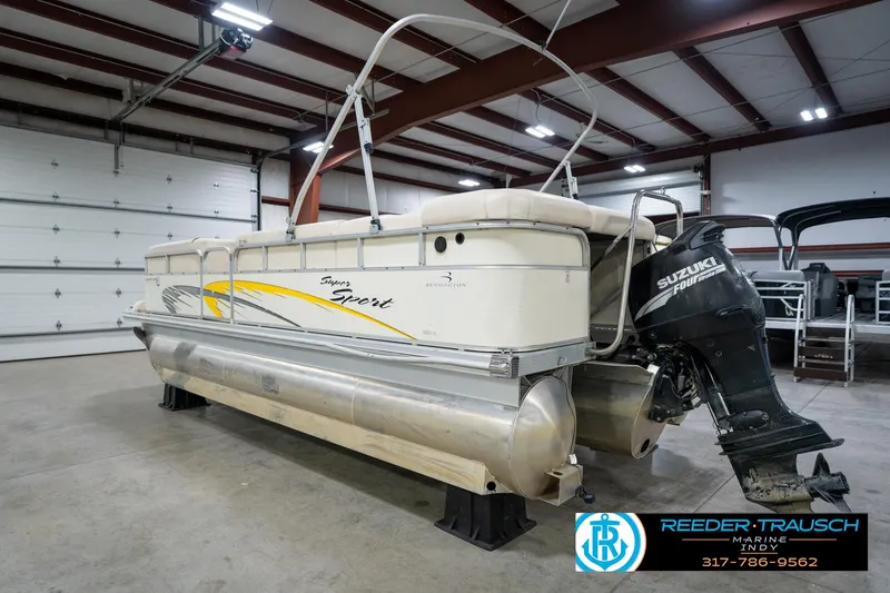 Slide: The Image of 2005 Bennington 2050 pontoon boat with Suzuki outboard motor in indoor storage. - 8