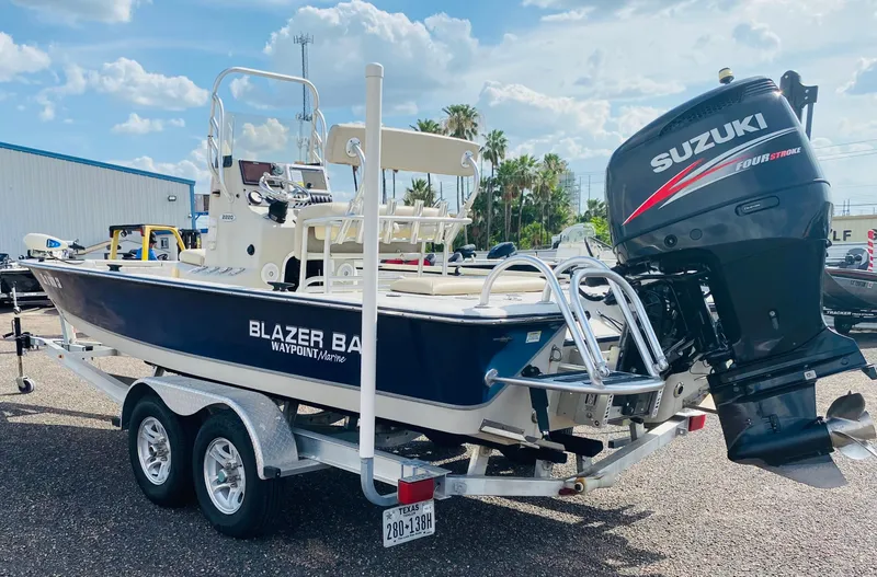 Slide: The Image of 2014 Blazer Bay 2200 Professional boat with Suzuki engine on trailer, sunny day. - 4