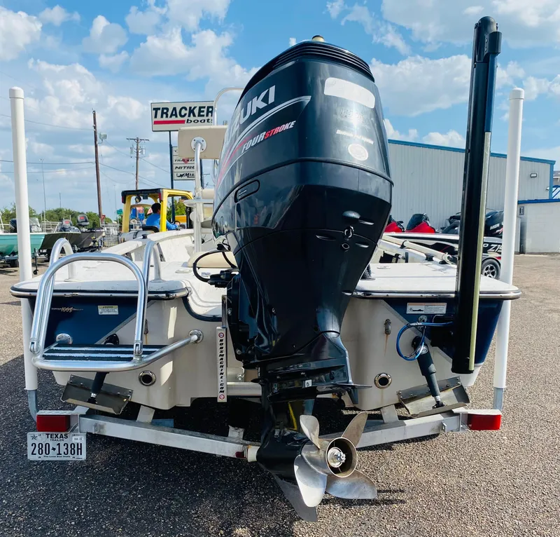 Slide: The Image of 2014 Blazer Bay 2200 Professional boat with Suzuki outboard motor, parked at Tracker Boats dealership. - 6
