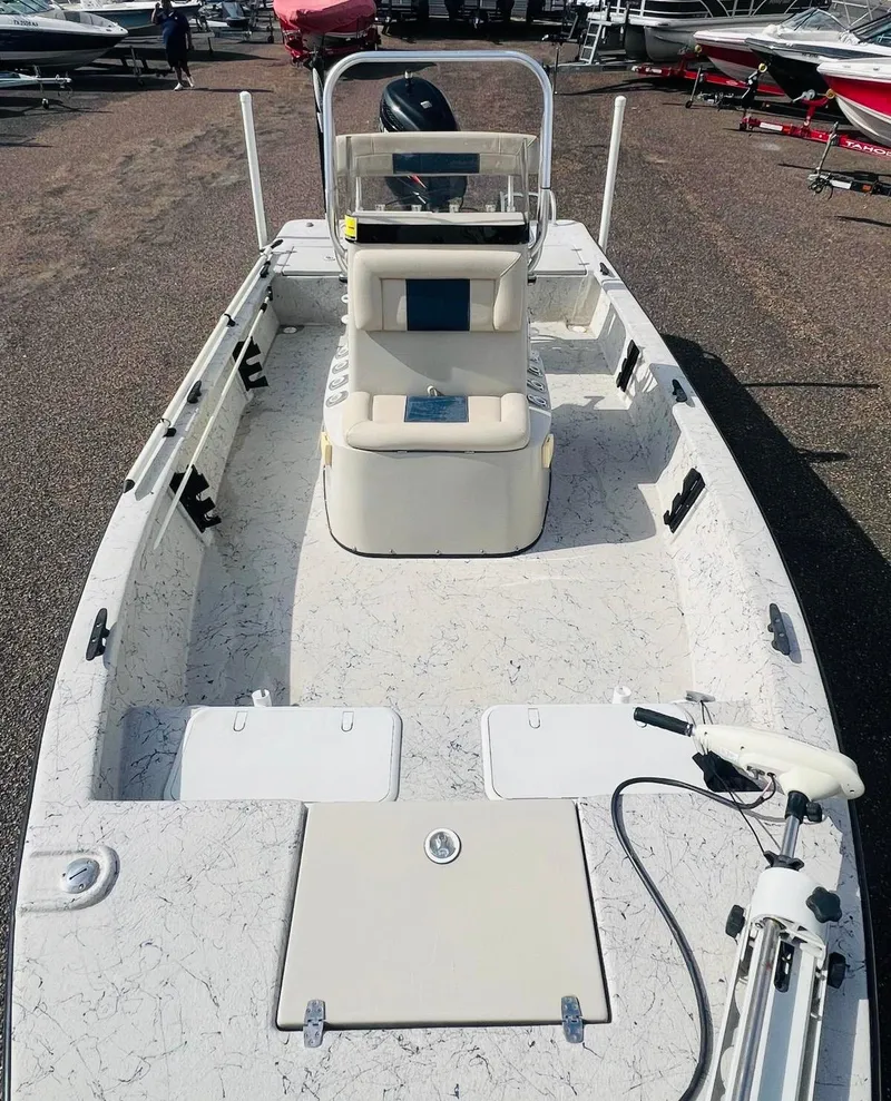 Slide: The Image of 2014 Blazer Bay 2200 Professional boat, spacious interior, parked among other boats. - 9