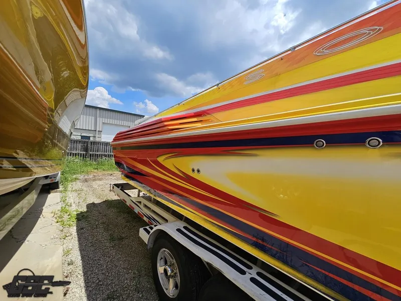 Slide: The Image of Colorful 2004 Sonic USA 45SS speedboat on trailer under blue sky. - 10