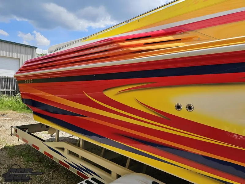 Slide: The Image of Colorful 2004 Sonic USA 45SS boat with vibrant red, yellow, and blue design. - 11