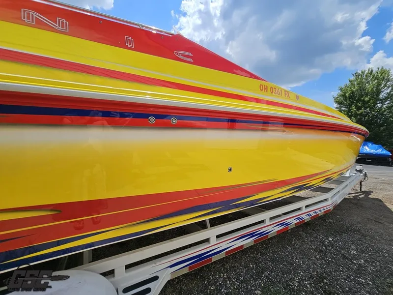 Slide: The Image of Colorful 2004 Sonic USA 45SS boat on trailer under blue sky. - 12