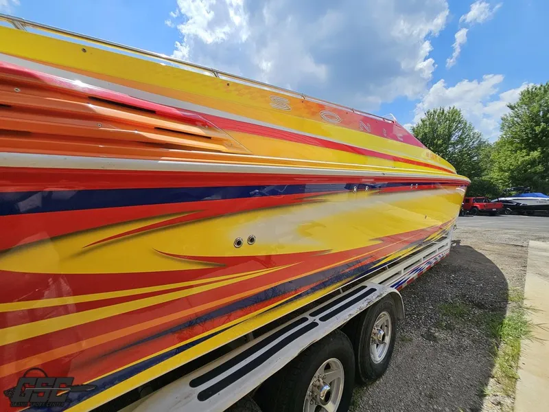 Slide: The Image of Colorful 2004 Sonic USA 45SS speedboat on trailer under blue sky. - 13