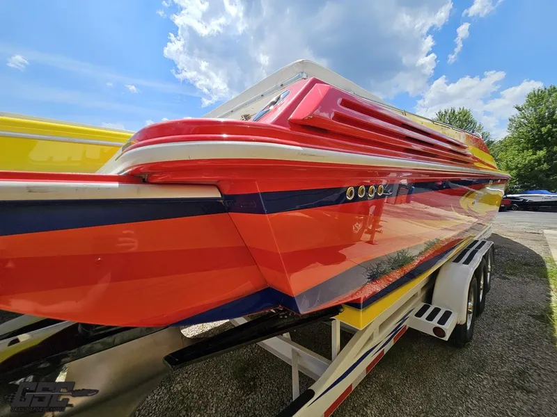 Slide: The Image of Colorful 2004 Sonic USA 45SS speedboat on trailer under blue sky. - 14