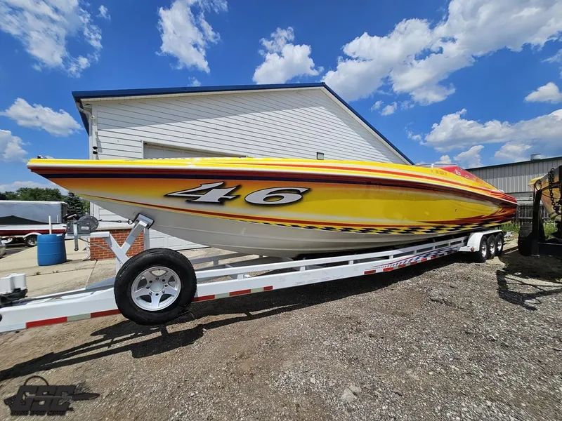 Slide: The Image of Yellow 2004 Sonic USA 45SS speedboat on trailer, parked outdoors under blue sky. - 16