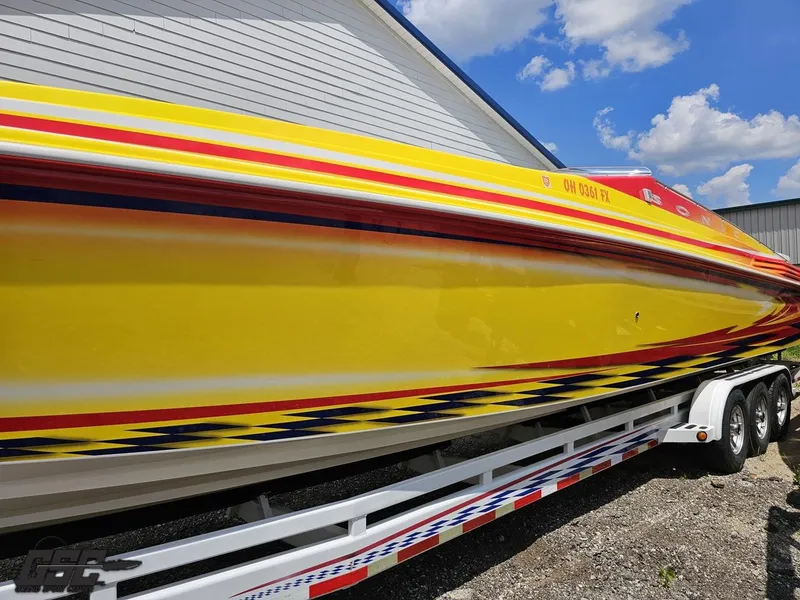 Slide: The Image of Bright yellow 2004 Sonic USA 45SS speedboat with vibrant red and blue accents on trailer. - 19