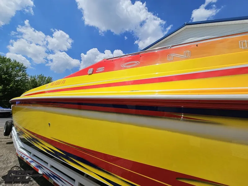 Slide: The Image of Colorful 2004 Sonic USA 45SS speedboat with vibrant yellow and red design under blue sky. - 21