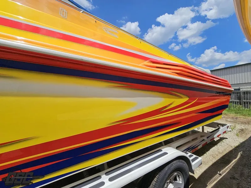 Slide: The Image of Colorful 2004 Sonic USA 45SS speedboat with vibrant yellow, red, and blue design. - 23