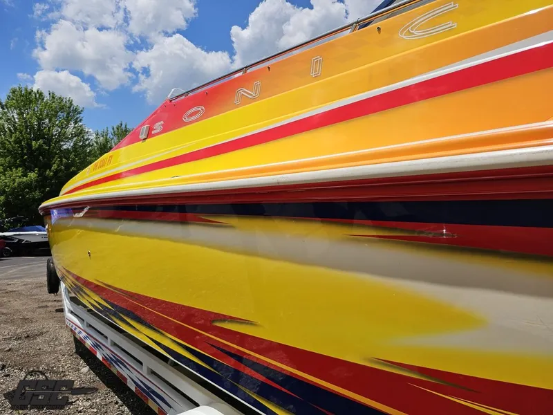 Slide: The Image of Colorful 2004 Sonic USA 45SS speedboat with vibrant graphics under a blue sky. - 24