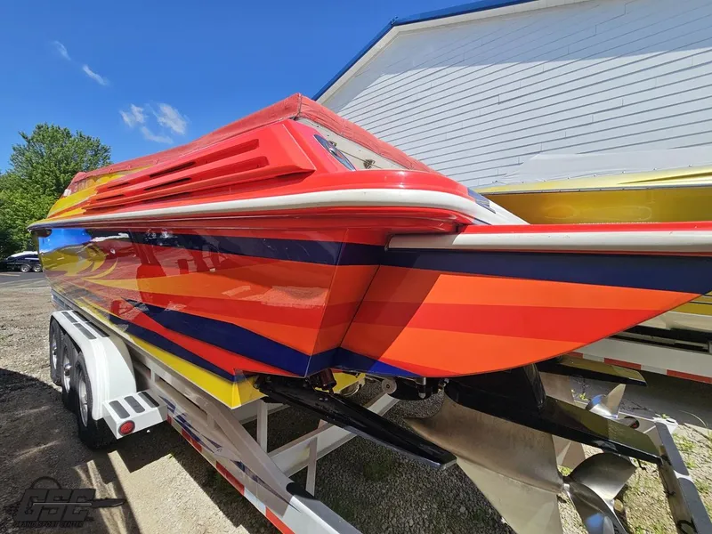 Slide: The Image of Colorful 2004 Sonic USA 45SS speedboat on trailer, vibrant stripes, sunny day. - 26
