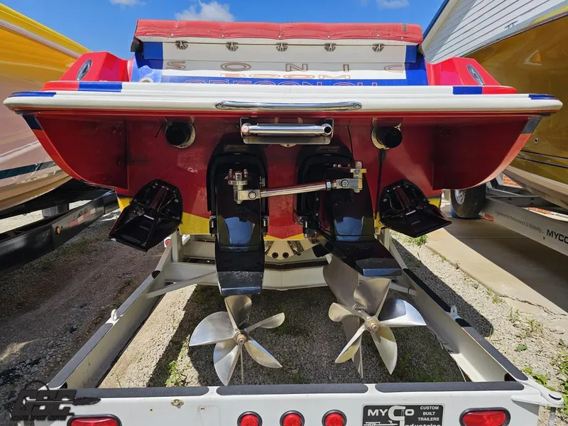 Slide: The Image of Rear view of a 2004 Sonic USA 45SS boat with dual propellers on a trailer. - 27