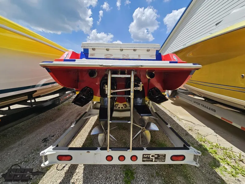 Slide: The Image of Rear view of a 2004 Sonic USA 45SS boat on a trailer, under a blue sky. - 29