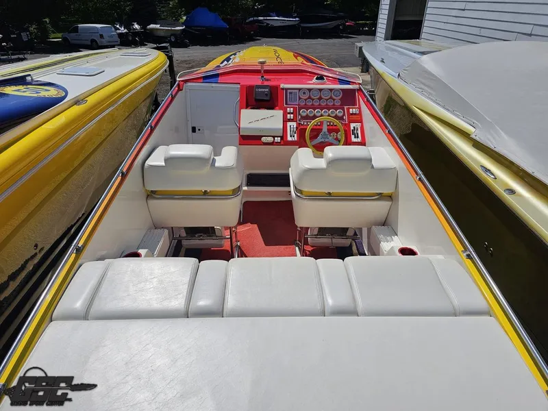 Slide: The Image of Interior of a 2004 Sonic USA 45SS speedboat with white seating and vibrant dashboard. - 36