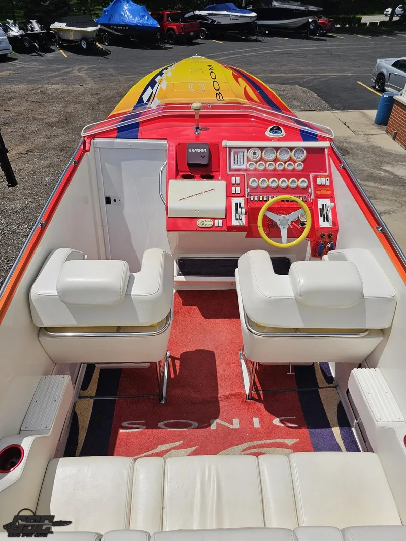 Slide: The Image of Interior of a 2004 Sonic USA 45SS speedboat with vibrant red and yellow dashboard. - 38