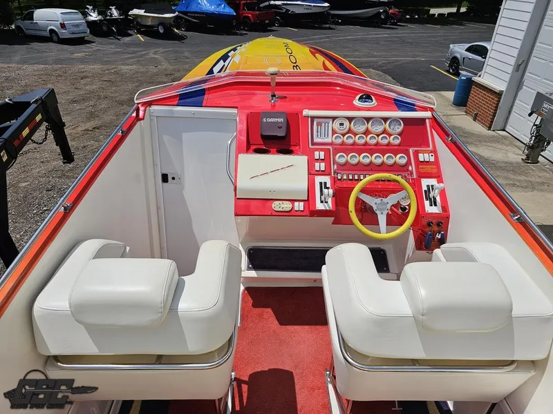 Slide: The Image of Interior of a 2004 Sonic USA 45SS speedboat with vibrant dashboard and white seating. - 40