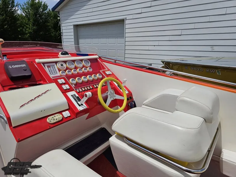 Slide: The Image of Cockpit of 2004 Sonic USA 45SS boat with red dashboard and yellow steering wheel. - 44